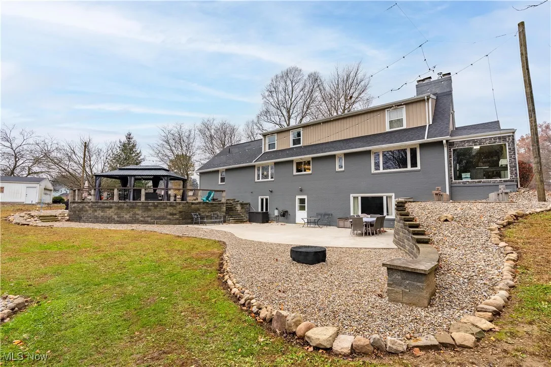 A view of the back of the home, patio and gazebo.