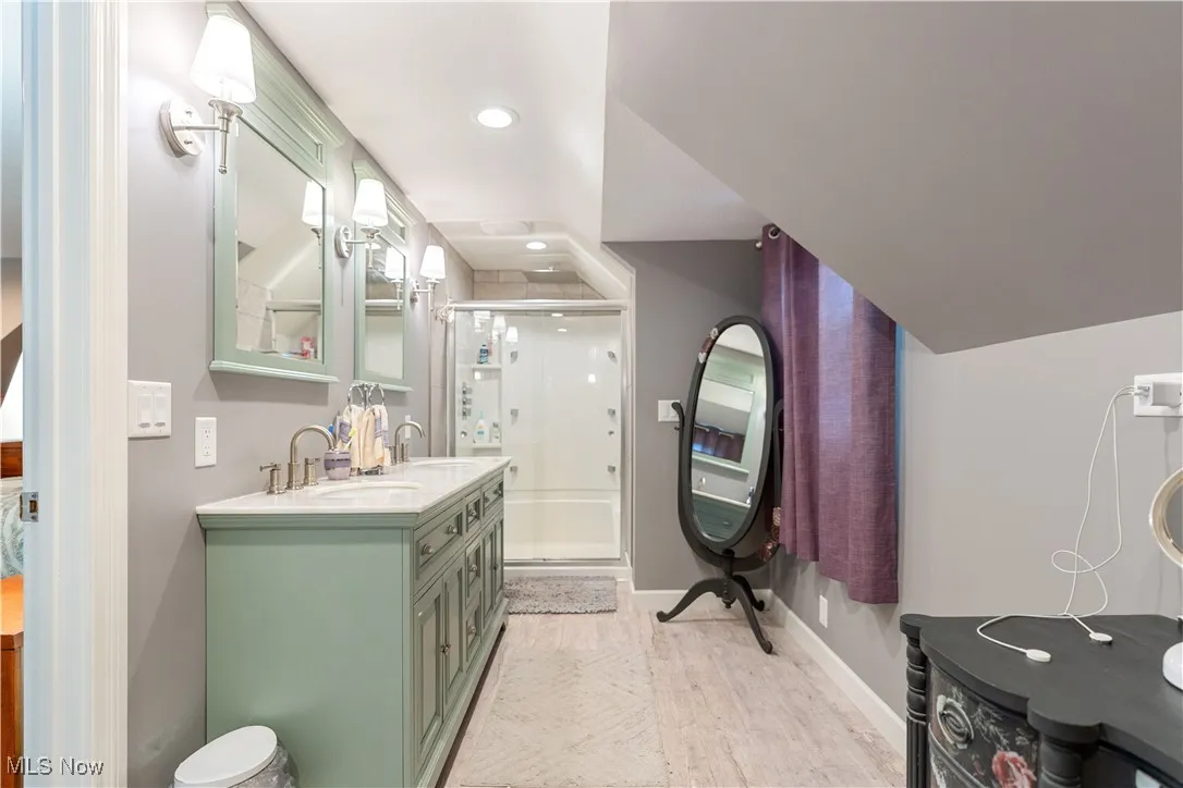 Dual vanity and walk-in shower in the master bath.