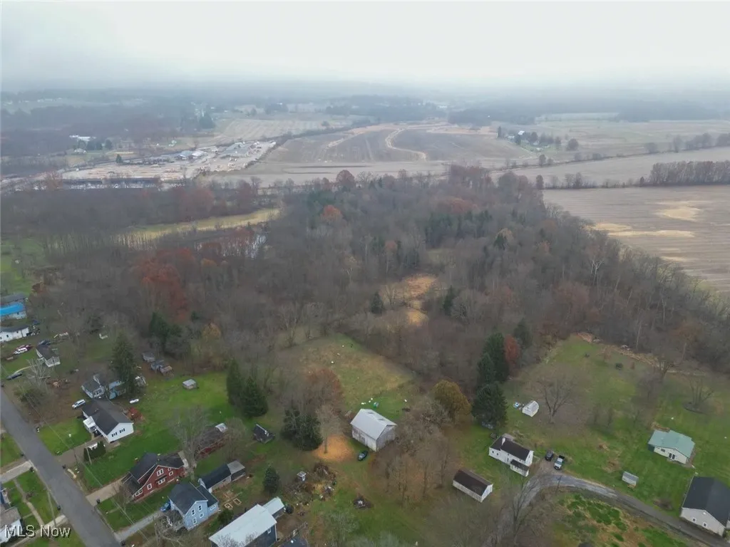 Aerial view of property and surrounding area featuring rural landscape