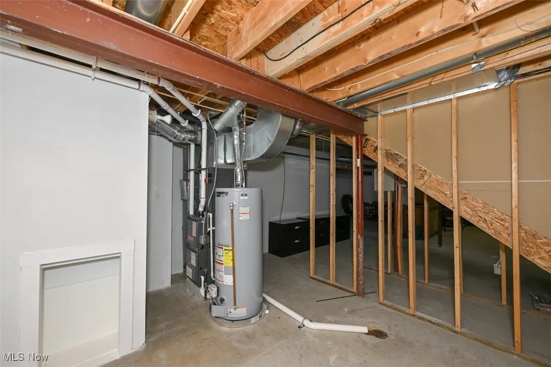 Unfinished basement featuring gas water heater