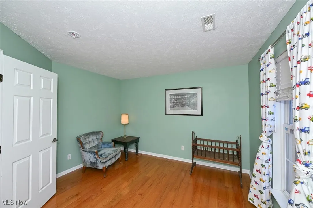 Bedroom 4 featuring wood flooring.