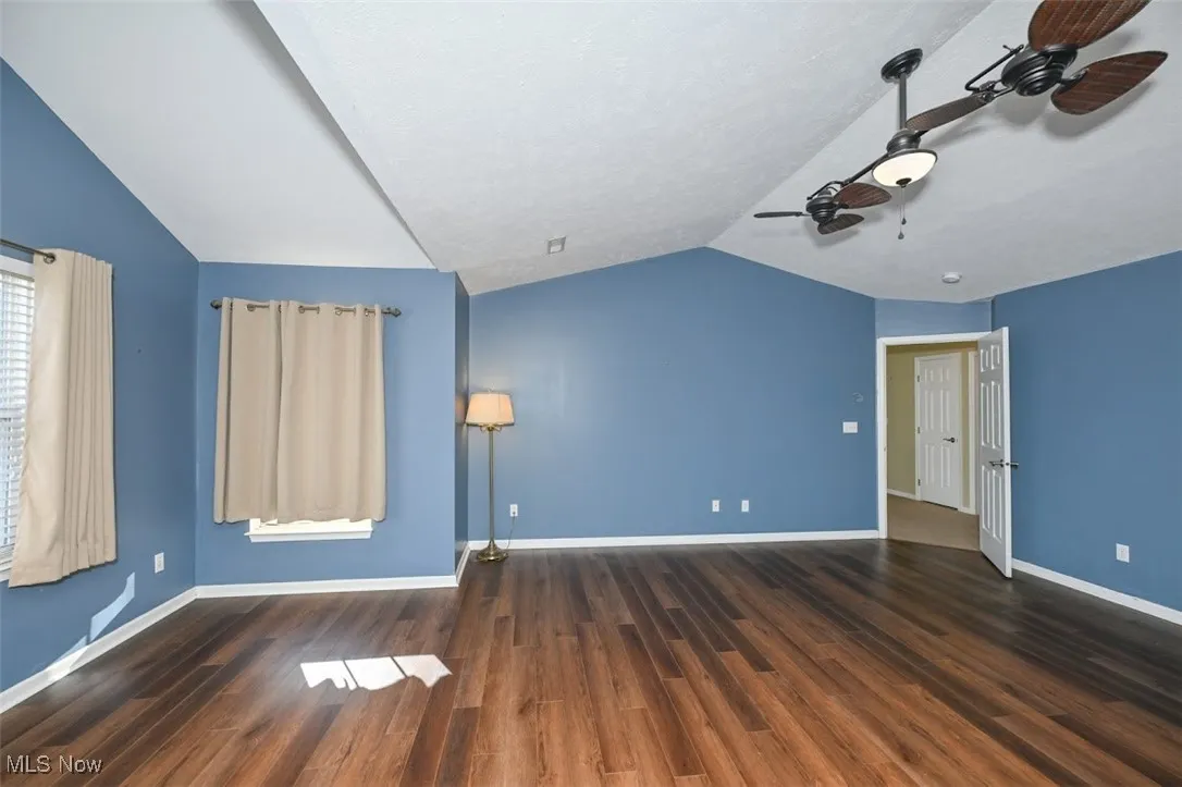 Primary bedroom with vaulted ceiling