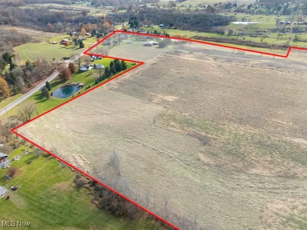 Overview of rural landscape with property parcel outlined and a nearby body of water