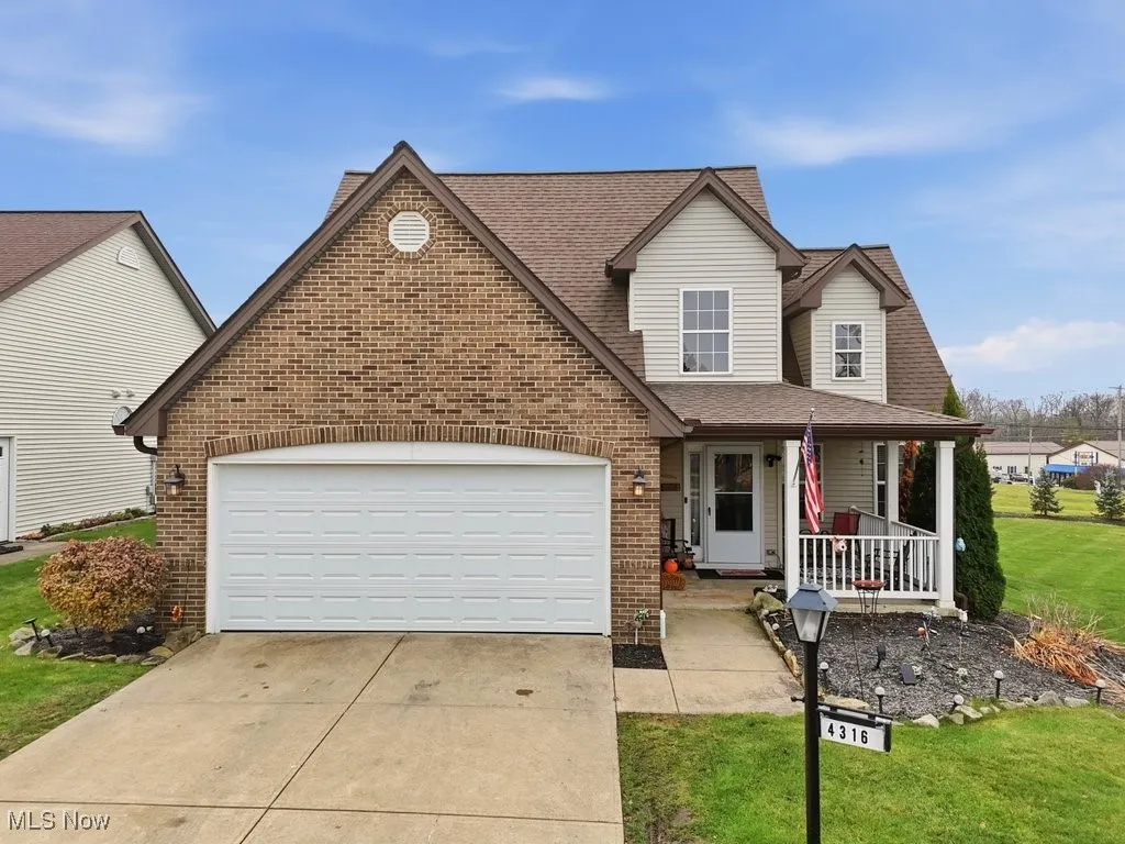 FRONT VIEW 2. ATTACHED GARAGE AND INVITING FROM PORCH.