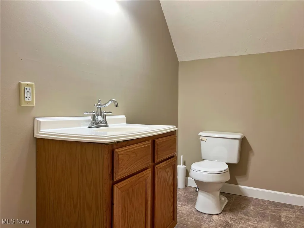 Bathroom with vanity and vaulted ceiling
