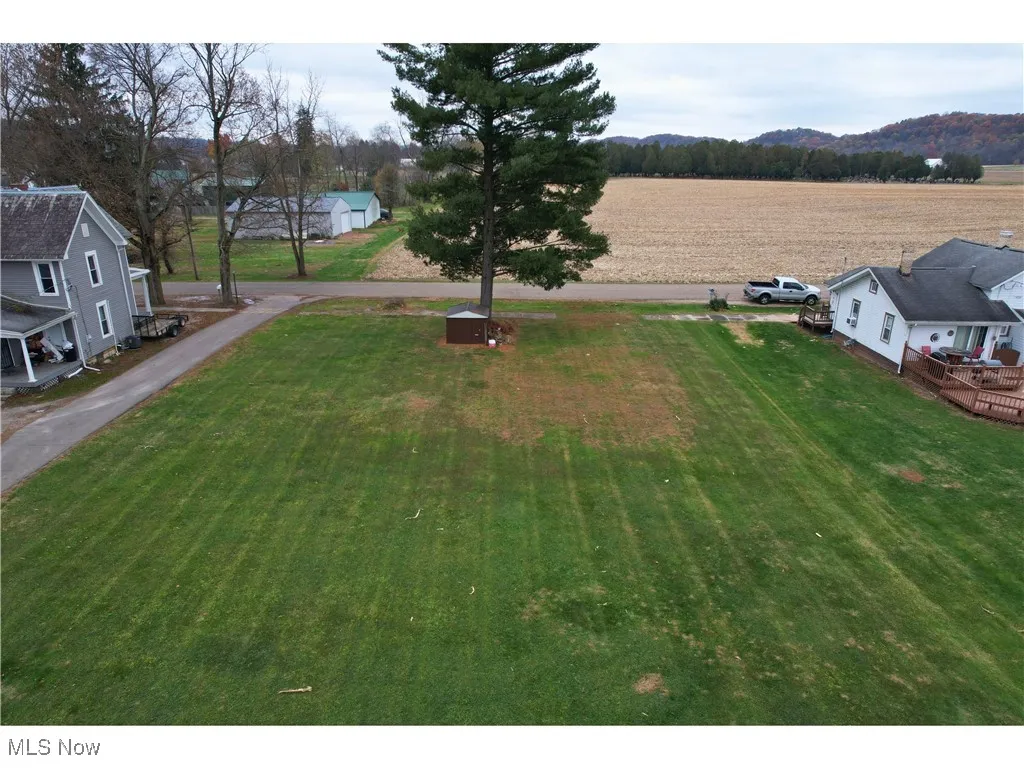 View of yard with agricultural area, a rural view, and a wooden deck