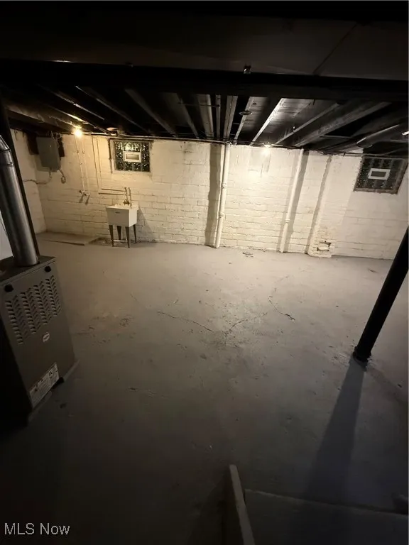 Unfinished basement featuring electric panel