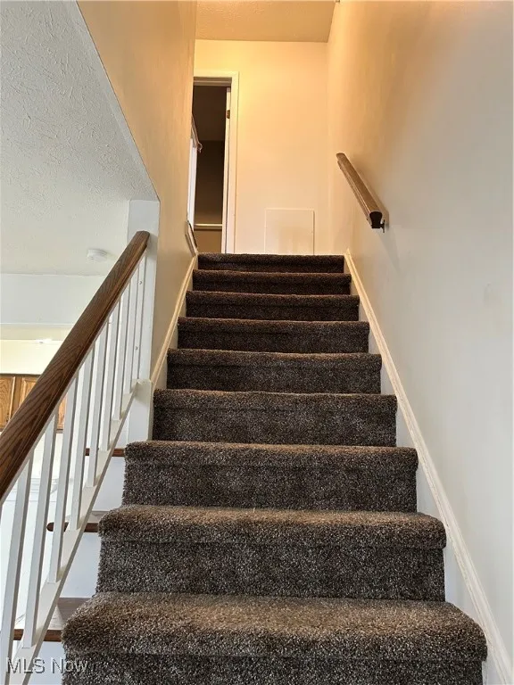 Stairs with a textured ceiling