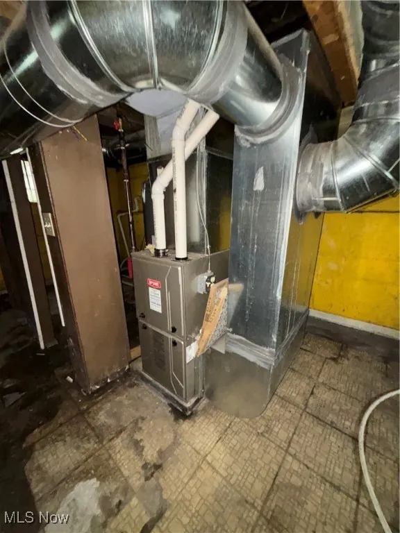 Utility room featuring heating unit