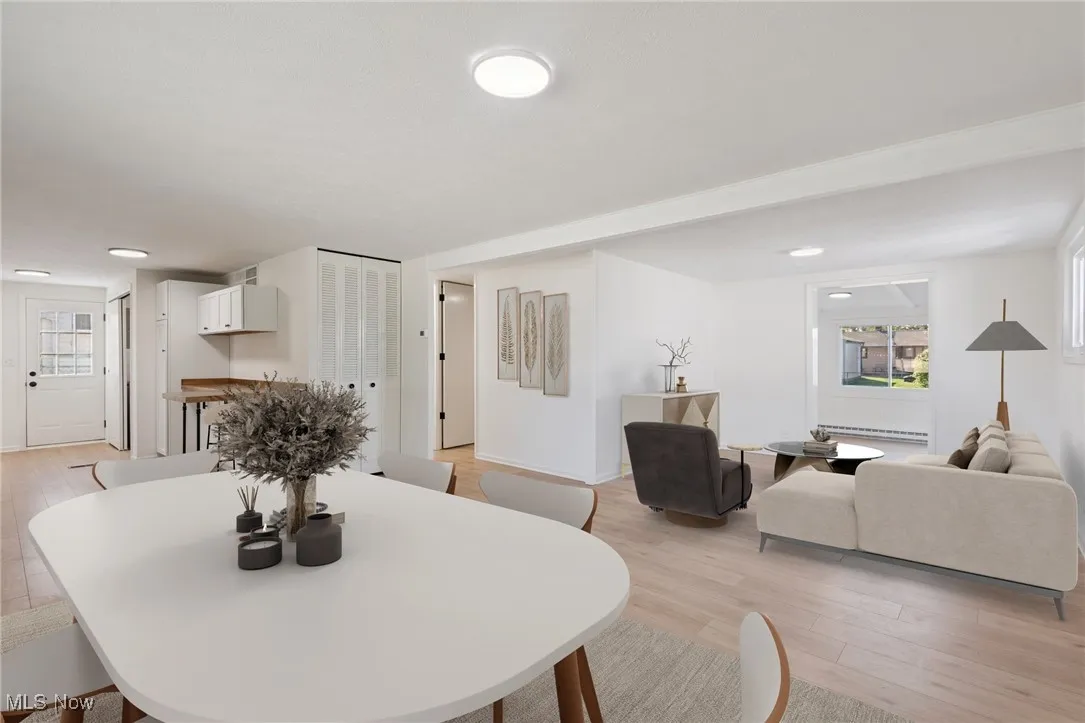 Dining room with plenty of natural light and light wood-style floors
