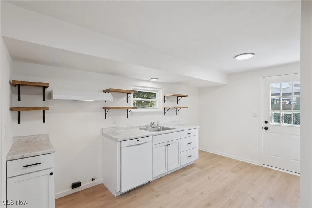 Laundry area with light wood finished floors