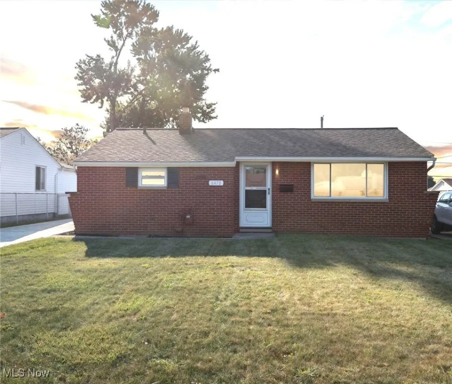Single story home with brick siding, a chimney, and a shingled roof