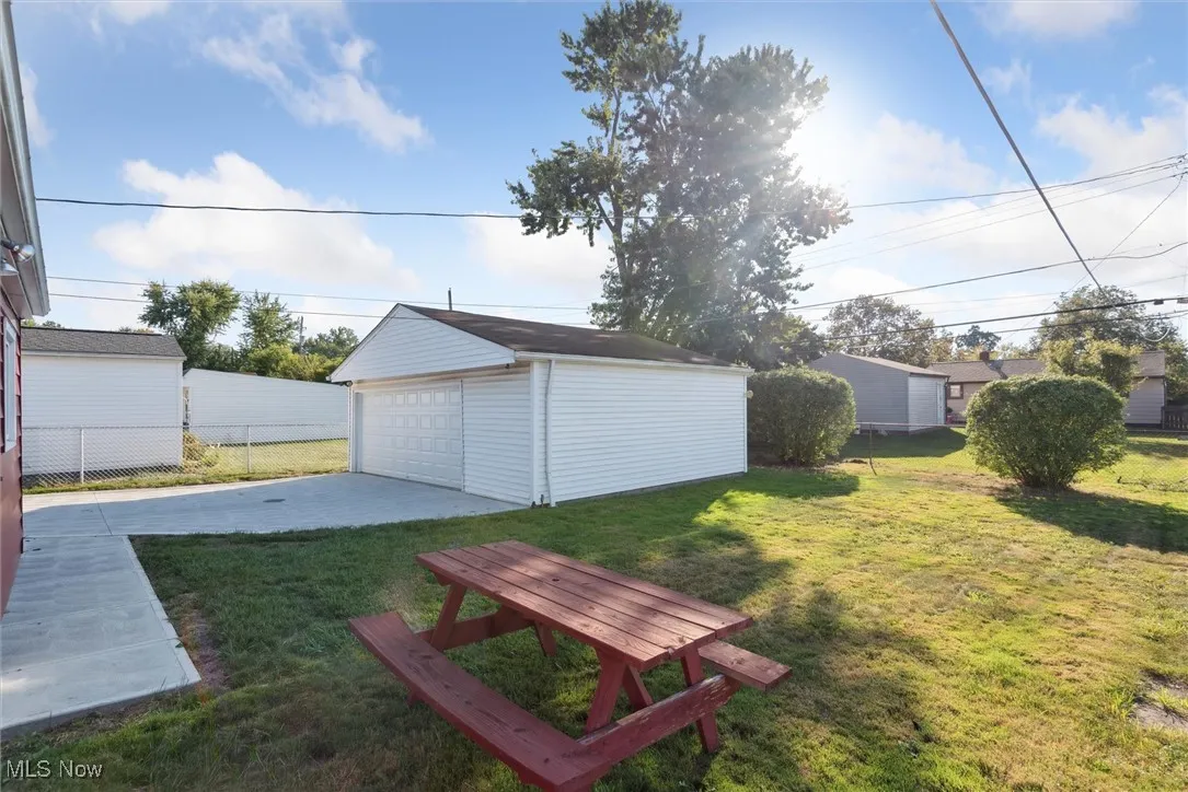 View of yard featuring an outbuilding and a garage