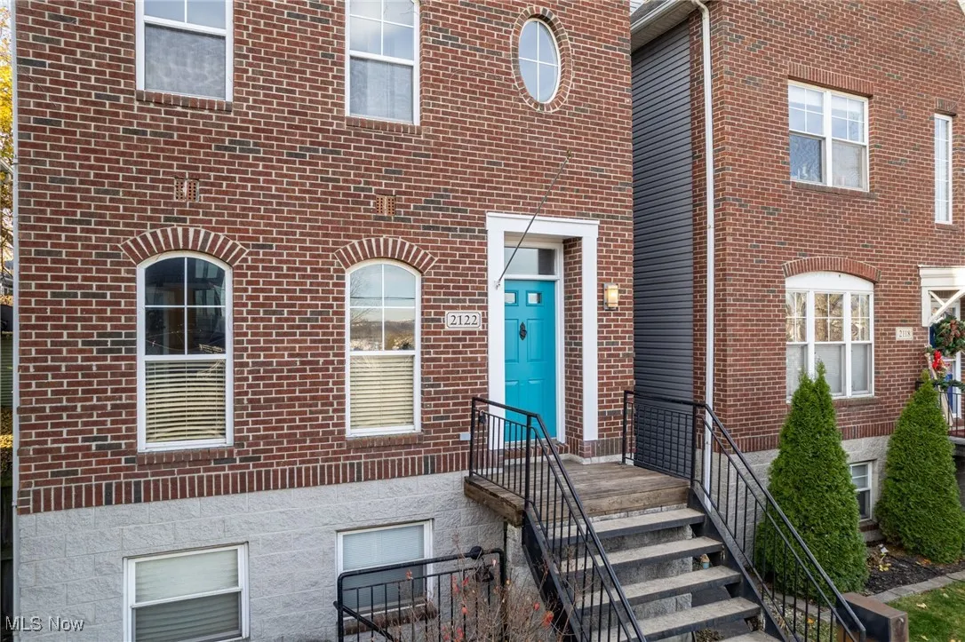 Doorway to property with brick siding