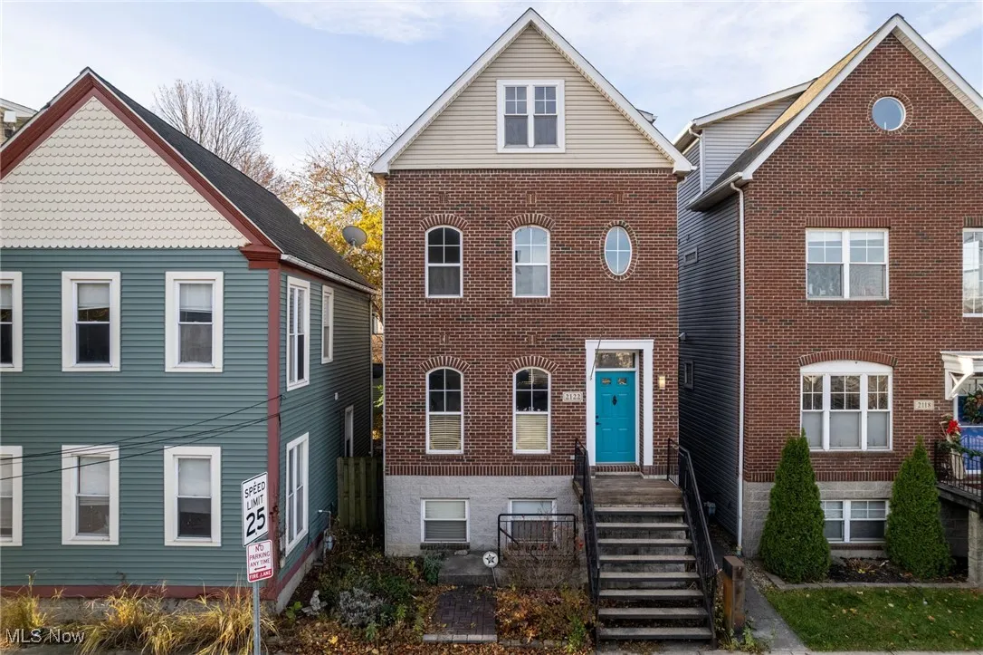 Traditional-style home with brick siding
