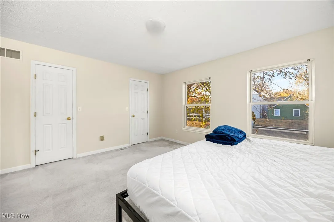 Bedroom featuring carpet floors and baseboards