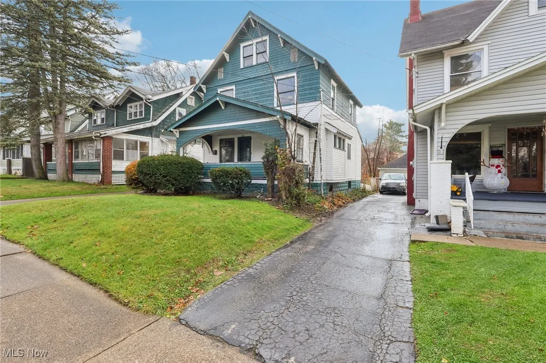 View of front of home with a front lawn and covered porch