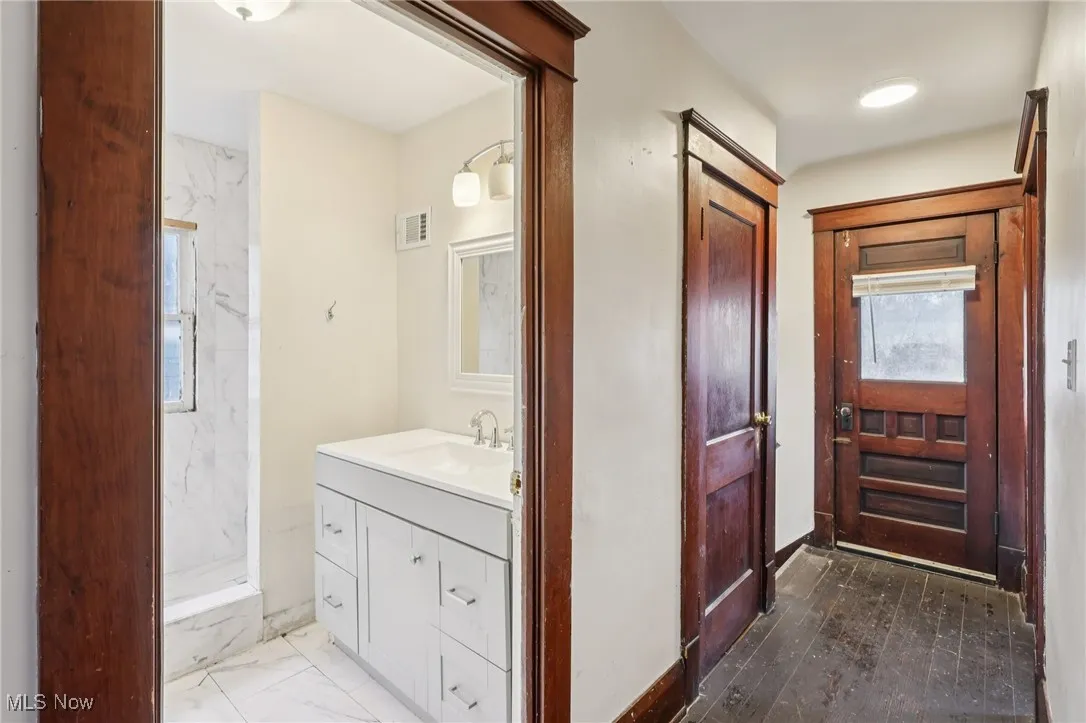 Bathroom with dark marble finish flooring and vanity