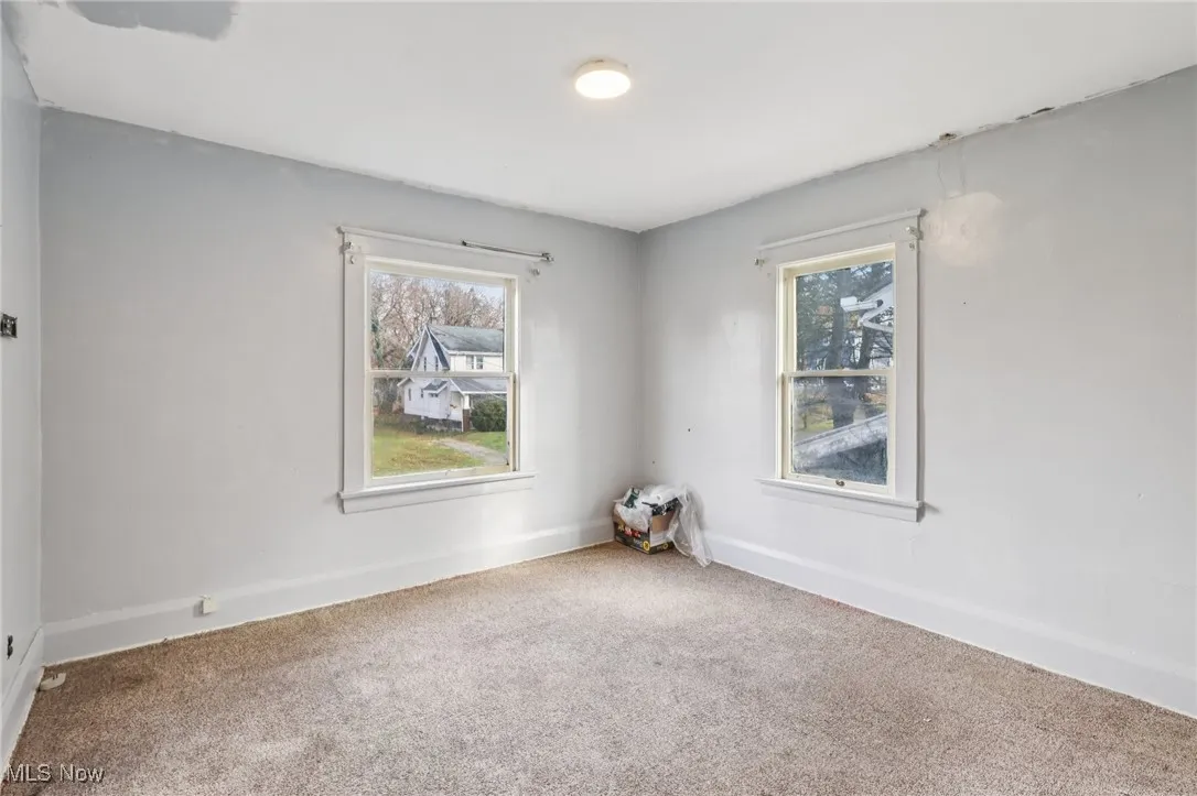Carpeted empty room with healthy amount of natural light