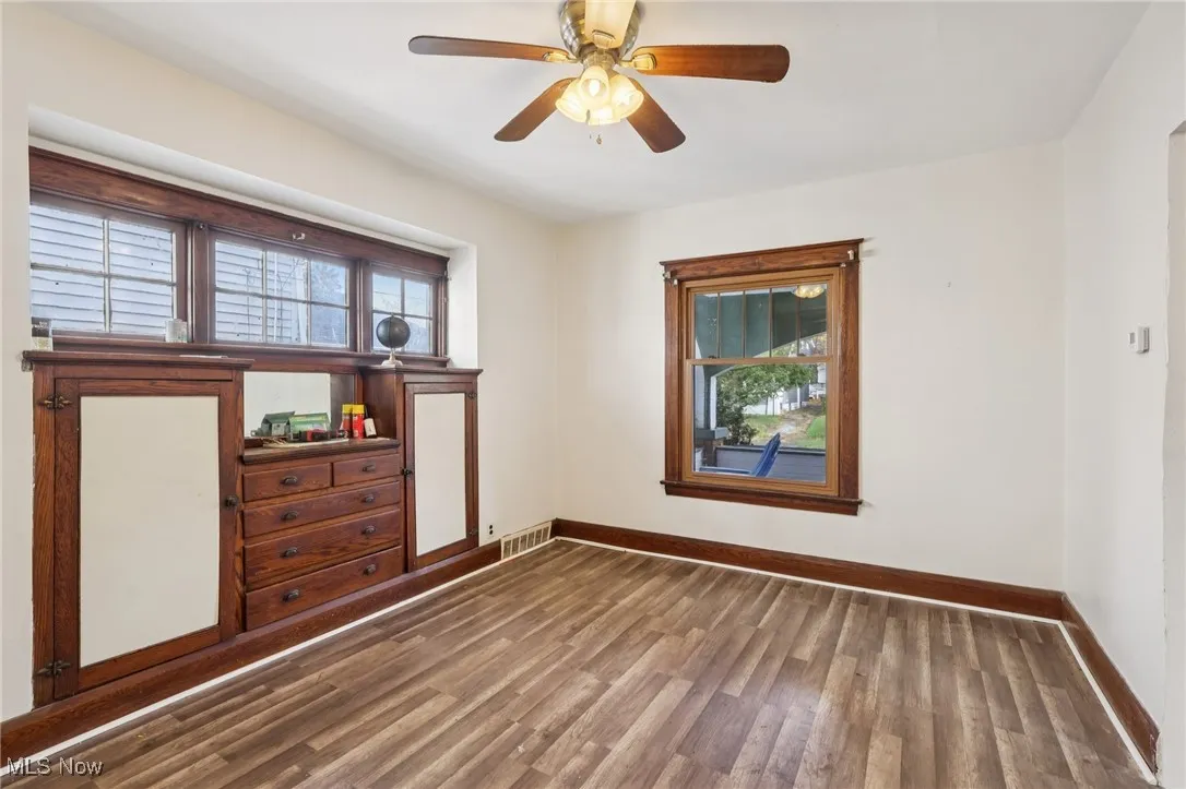 Unfurnished room featuring wood finished floors and ceiling fan