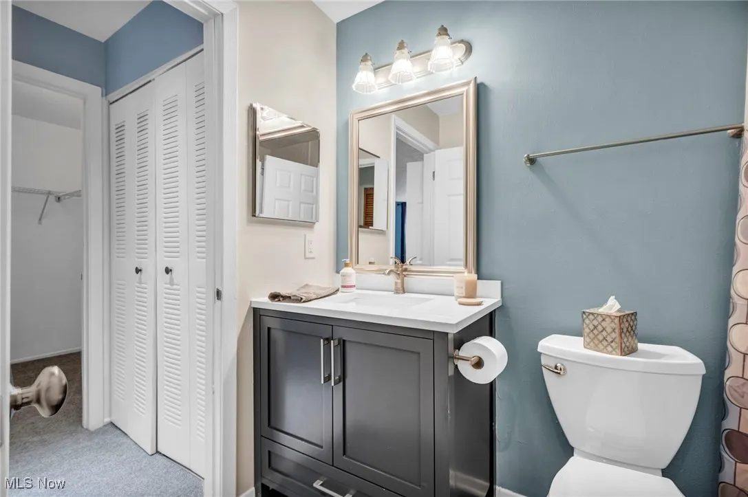 Bathroom with vanity and carpet floors