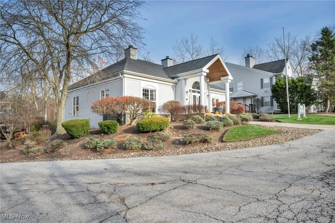 View of side of home with a chimney and a shingled roof