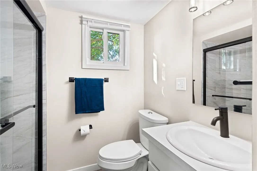 Full bathroom featuring a stall shower and vanity