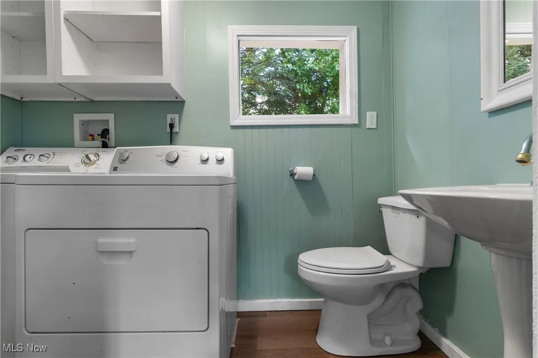 Bathroom featuring washer / dryer and dark wood-style floors