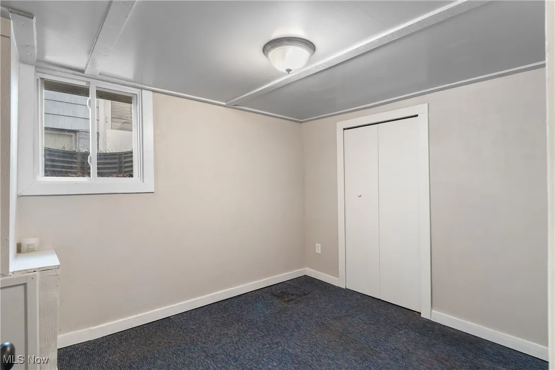 Unfurnished bedroom with a closet and carpet flooring