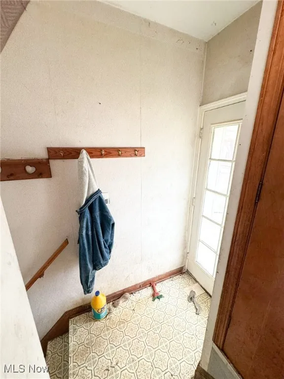 Laundry room featuring baseboards