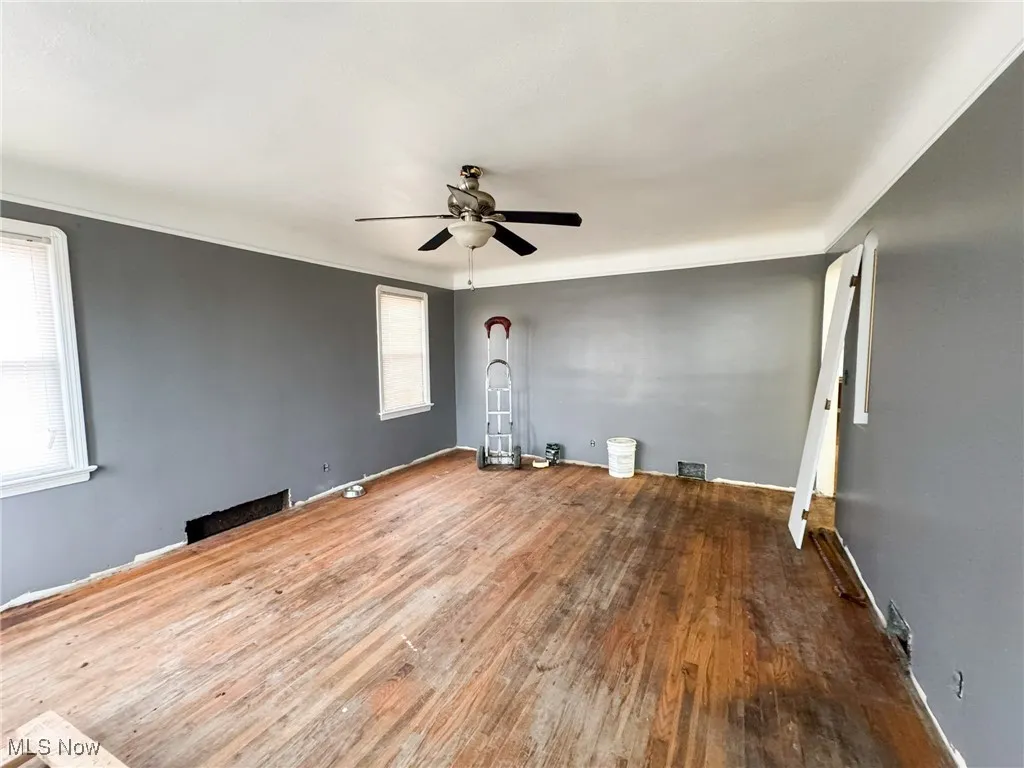 Empty room featuring hardwood / wood-style floors and ceiling fan