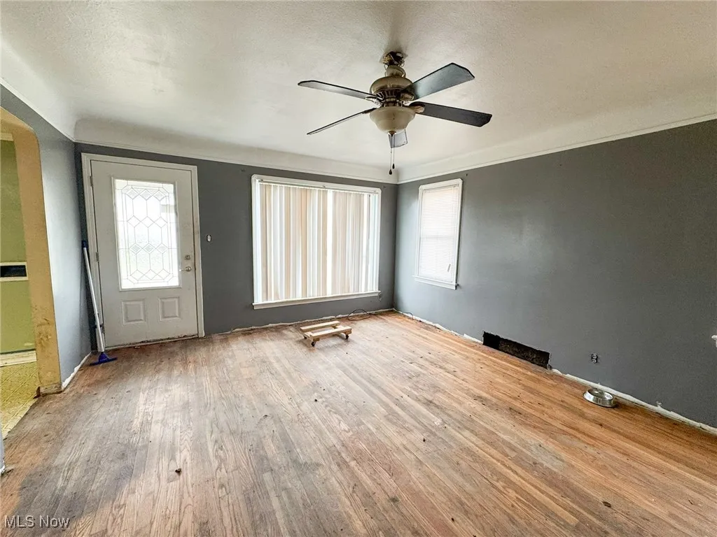 Foyer featuring a textured ceiling, wood-type flooring, and a ceiling fan