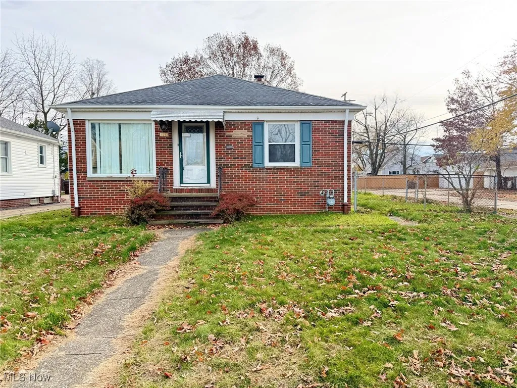 Bungalow featuring brick siding, entry steps, and a shingled roof
