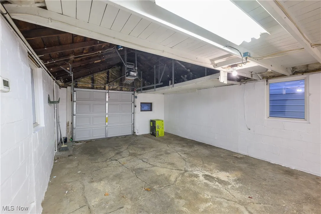 Garage with concrete block wall and a garage door opener