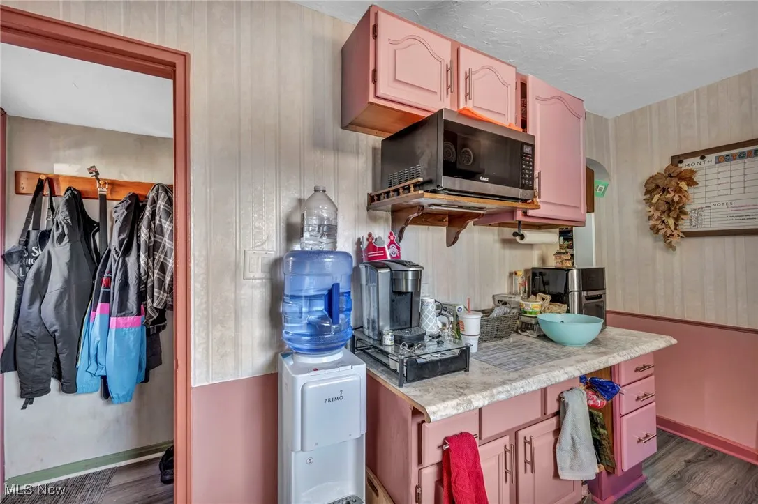 Kitchen with light countertops and dark wood-style flooring