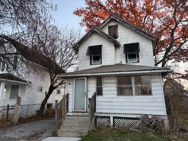 Traditional style home with roof with shingles
