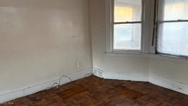 Spare room featuring baseboards