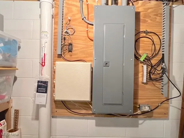 Utility room featuring electric panel and a central vacuum unit