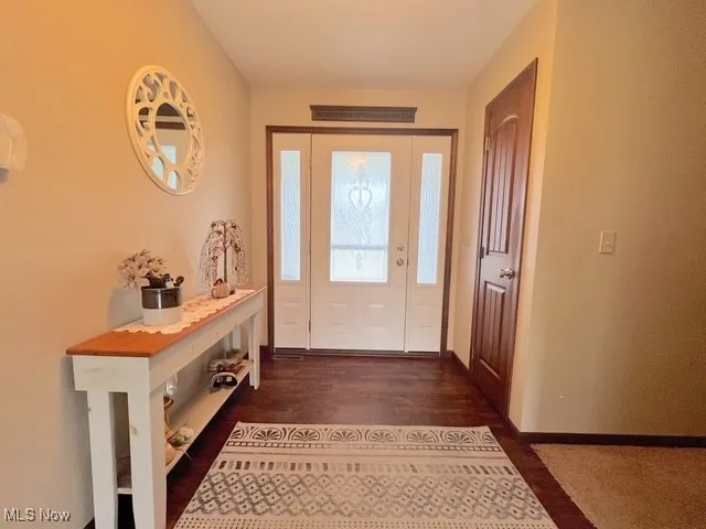 Foyer featuring dark wood-type flooring