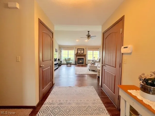 Corridor featuring dark wood-style flooring