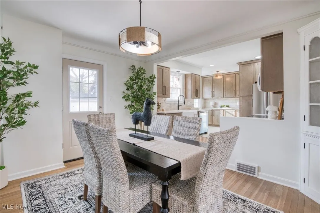 Dining room with light wood finished floors and baseboards
