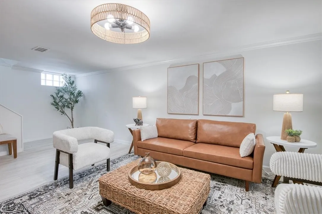 Living room featuring crown molding and wood finished floors