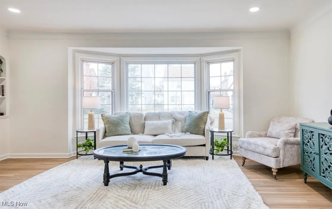 Living area with recessed lighting, plenty of natural light, and light wood finished floors