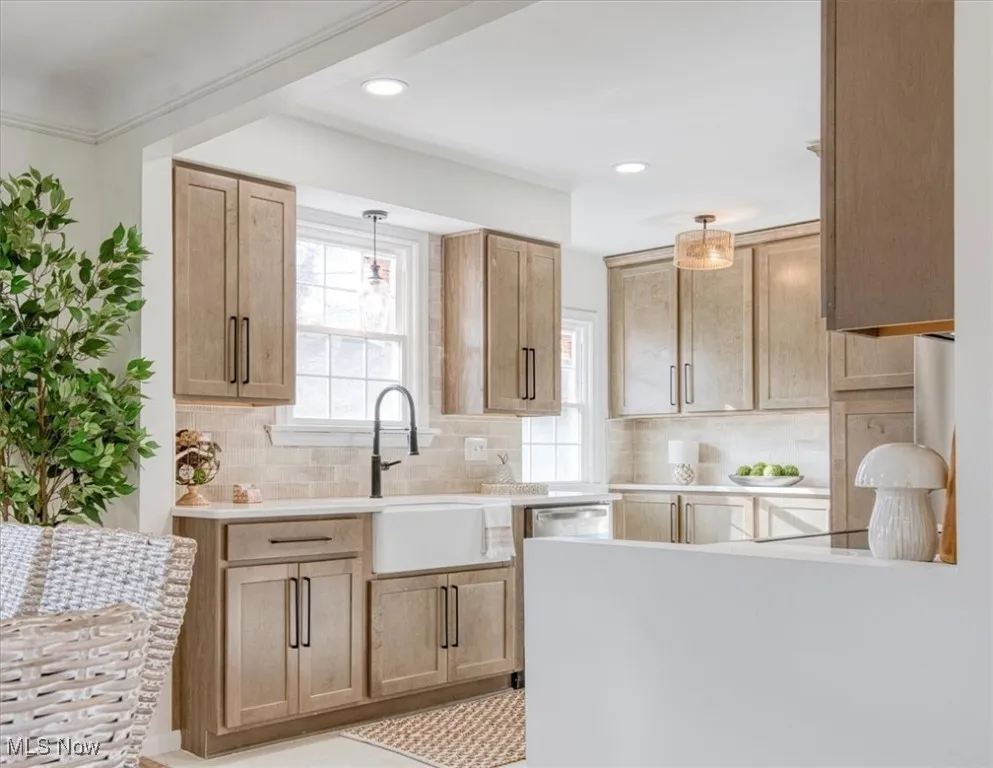 Kitchen with pendant lighting, backsplash, healthy amount of natural light, recessed lighting, and light brown cabinetry