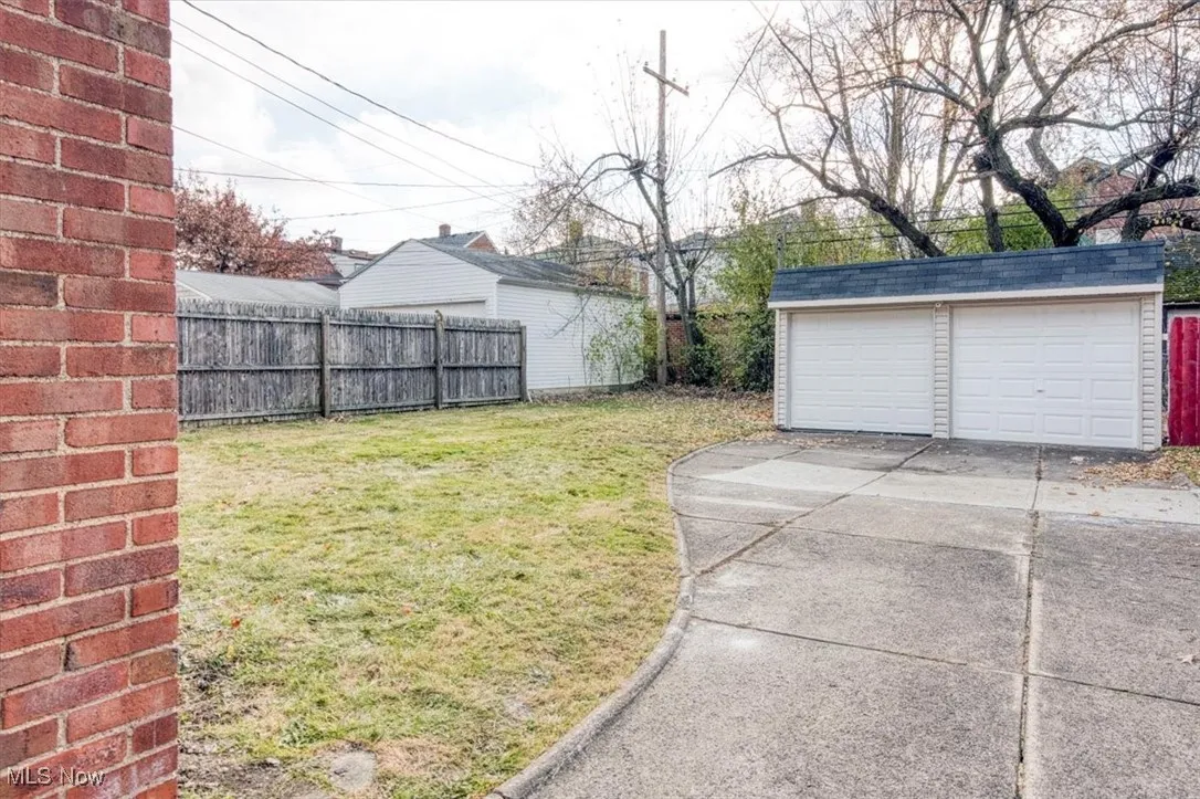 View of yard with an outdoor structure and a detached garage