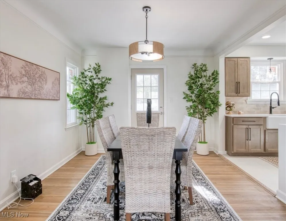 Dining area featuring light wood-style floors and baseboards