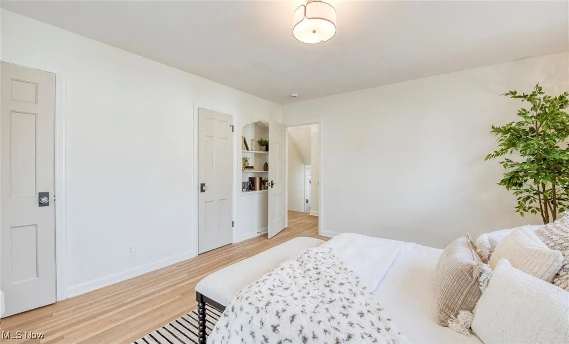 Bedroom featuring light wood-style floors and baseboards