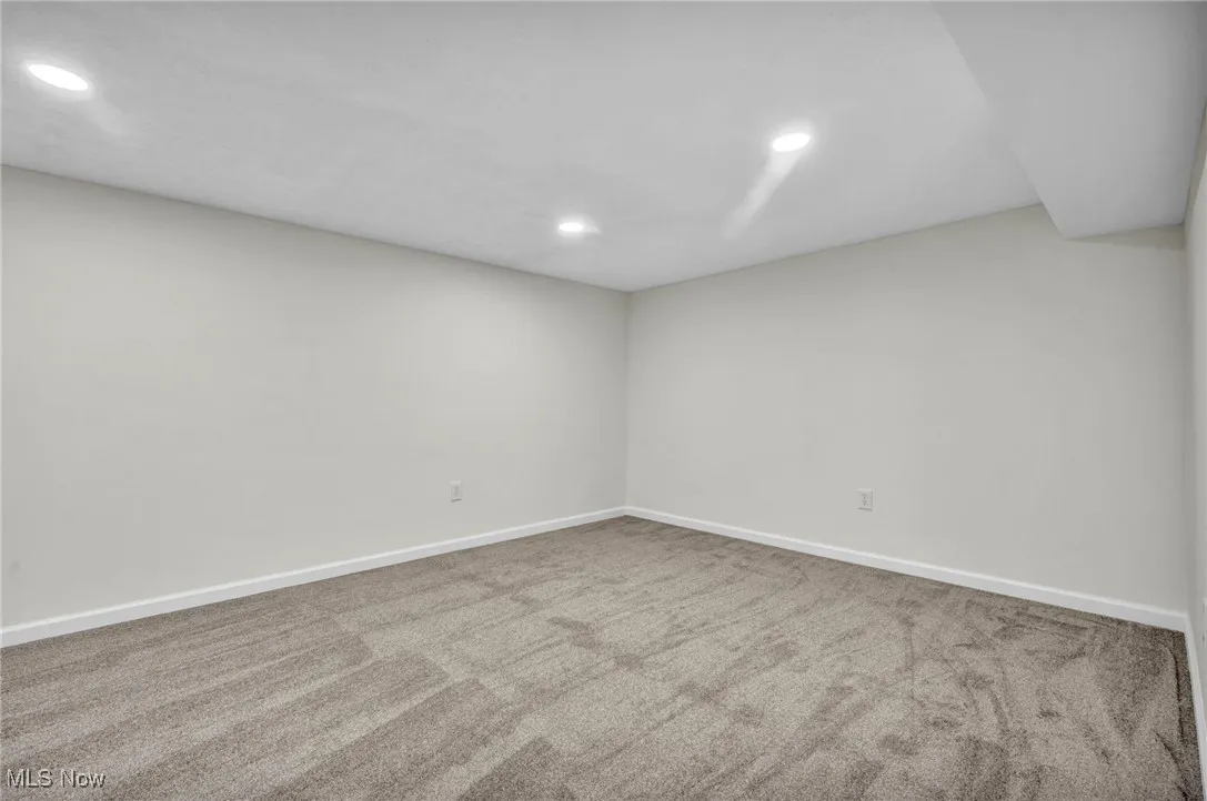 Unfurnished room with recessed lighting and light colored carpet