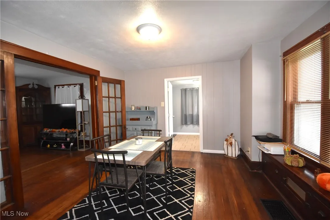 Office area featuring dark wood-style floors and baseboards