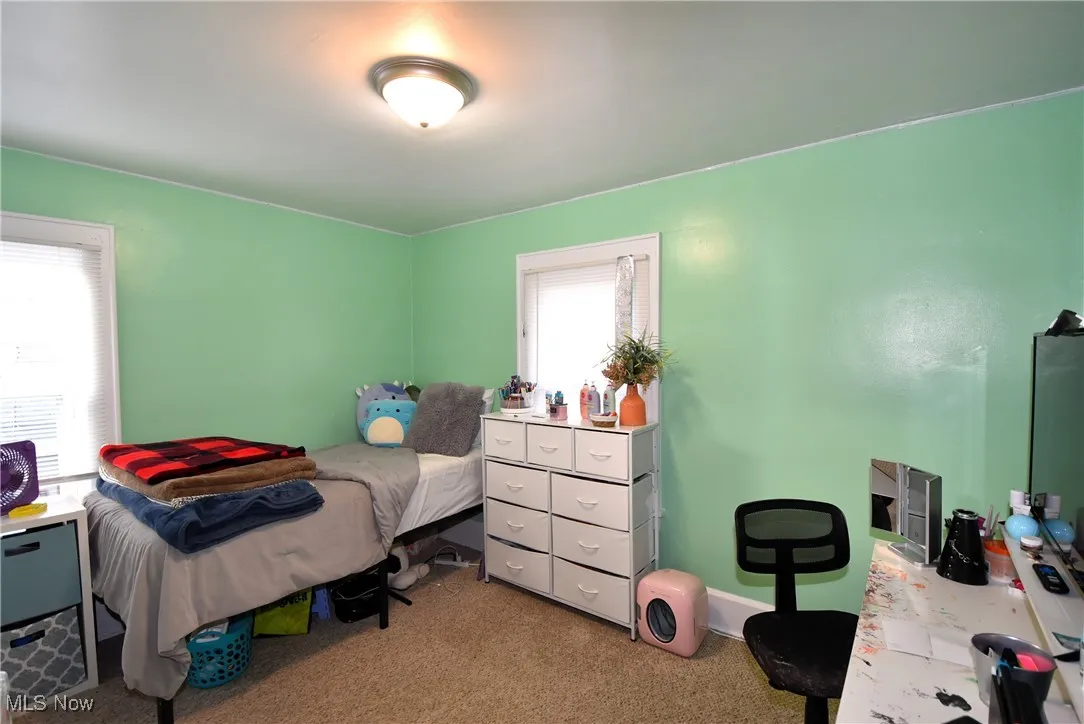 Bedroom with carpet floors and baseboards